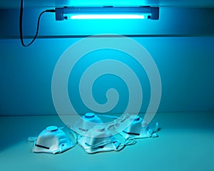 Protection and safety of medical workers.Protective masks N95 are sterilized under ultraviolet light photo
