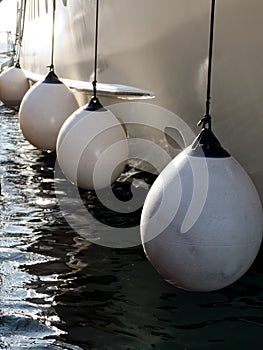 Protection of a side of a boat in the port photo