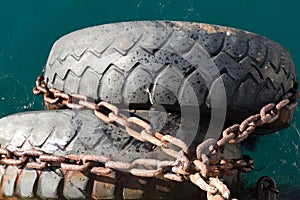 Protection of a side of a boat in the port photo