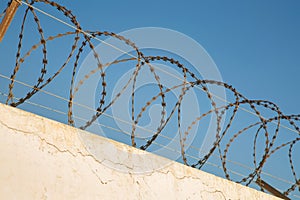 Protective barbed wire on the wall