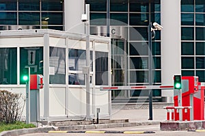 The protective barrier and security office at the entrance to the office parking lot