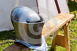 Protective clothing armor metal helmet of the knight of the Middle Ages life saving in the war stands on the bench in front of the