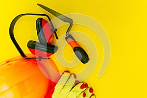 Protective equipment and tools in a bag for the builder on a yellow background