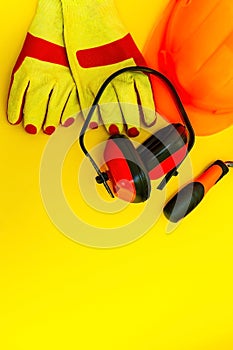 Protective equipment and tools in a bag for the builder on a yellow background