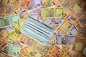 Protective face mask and Indian paper currency