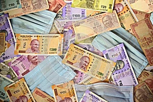 Protective face mask and Indian paper currency