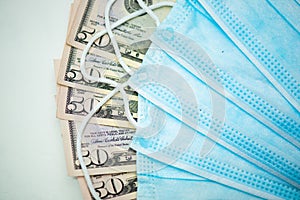 Protective face masks with dollar bills. Speculation and rising medicine prices. Business for people`s health. COVID 19