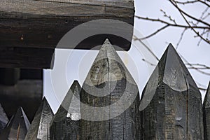 A protective fence made of logs with sharp upper ends, used in ancient Russia to protect against enemies.