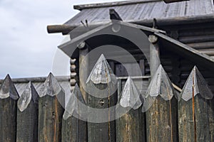 A protective fence made of logs with sharp upper ends, used in ancient Russia to protect against enemies.