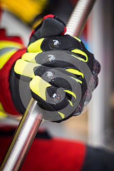 Protective Firefighter Gloves Holding Iron Bar