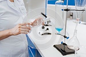 Protective glasses being held by a medical researcher