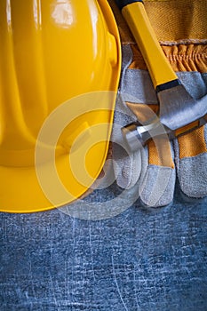 Protective gloves yellow building helmet and metal