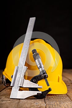 Protective helmet and measuring tools. Work accessories for production workers and engineers