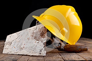 Protective helmet and tools for bricklayer. Work accessories for production workers