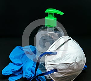 Protective mask , blue latex gloves and transparent plastic botle with antibacterial sanitizer fluid