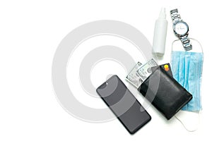 Protective mask, sanitizer, watch, phone, wallet with money, mens accessories on white table with copy space. Concept of