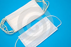 Protective medical disposable masks. White face masks, protection against viruses and bacteria, on a blue background, for