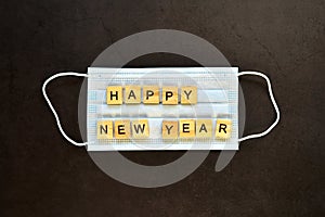 Protective medical mask with the inscription happy new year. Concept of gratitude and support to medical professionals. Concept of