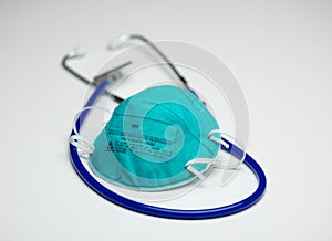 Protective Respirator on Top of Blue Stethoscope