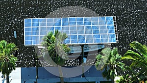 Protective roof over private recreational boat covered with solar photovoltaic panels. Shade cover with renewable