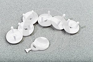 Protective Socket plugs on gray background  child safety  - image