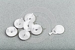 Protective Socket plugs on gray background  child safety  - image