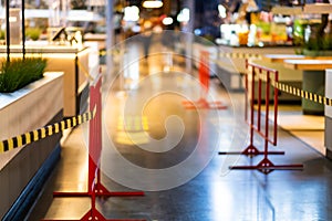 Protective tape covers tables and chairs on the food court in the mall due to a knockdown during the pandemic