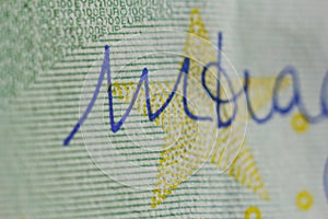 Protective watermark on a hundred euro bill in macro. protection against counterfeiting of banknotes. hologram. detail of paper