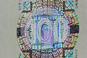 Protective watermark on a hundred euro bill in macro. protection against counterfeiting of banknotes. hologram. detail of paper