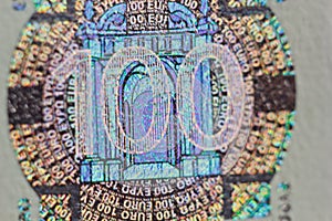 Protective watermark on a hundred euro bill in macro. protection against counterfeiting of banknotes. hologram. detail of paper