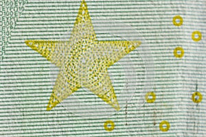 Protective watermark on a hundred euro bill in macro. protection against counterfeiting of banknotes. hologram. detail of paper