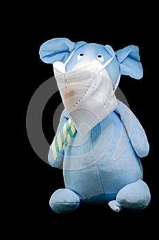 protective white medical mask on a plush mouse