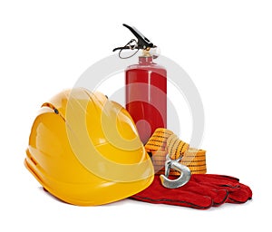 Protective workwear and fire extinguisher on white background.