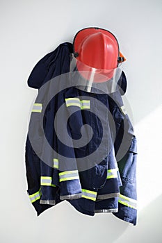 Protective workwear hanging against white wall