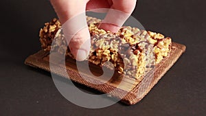 Protein bars with muesli and nuts on a dark background.