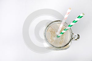 Protein cocktail with milk, vanilla in a glass jar with straws. Sports nutrition