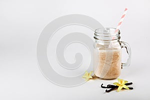 Protein cocktail with milk, vanilla in a glass jar with straws. Sports nutrition