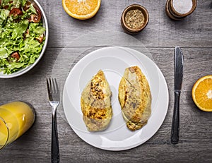 Protein food for athletes, chicken curry, a salad of fresh vegetables, fresh orange juice wooden rustic background top view clo