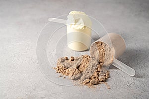 Protein vanilla and chocolate powder and protein drinks, with scoops. Food supplement, bodybuilding, fitness and sport