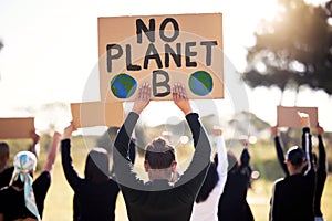 Protest, climate change and sign with a group of people outdoor at a rally or march for conservation. Global warming