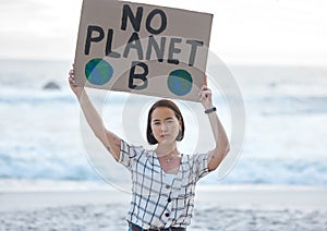 Protest, climate change and woman with a sign on the beach to stop pollution and global warming. Political, earth