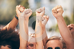 Protest, group and fist of people, hands in air for solidarity, equality and power women together outdoor. Diversity