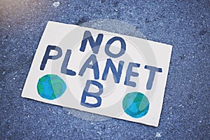 Protest poster, billboard or climate change sign on city street for planet earth, globe or world sustainability. Zoom on