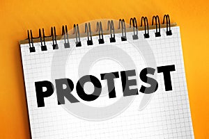 Protest - a statement or action expressing disapproval of or objection to something, text concept on notepad