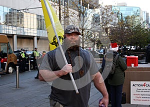 Protestants with posters marching in downtown of Vancouver, Canada