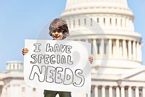 Protester boy holding sign I have special needs