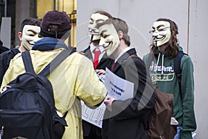 .A protester wearing a Guy Fawkes mask holds a placard