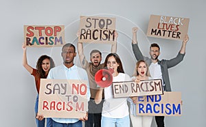 Protesters demonstrating different anti racism slogans on light background. People holding signs with phrases