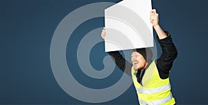 Protests yellow vests. Young man is holding poster. Concept of revolution and protest on blue background