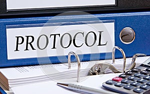 Protocol - blue binder with text in the office